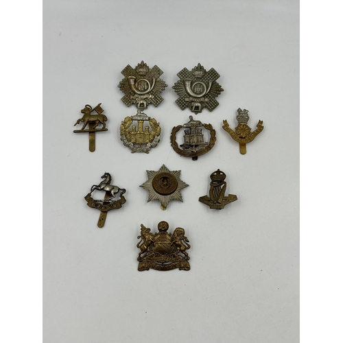 2177 - A collection of military cap badges