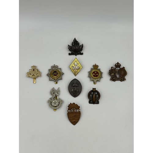 2178 - A collection of military cap badges