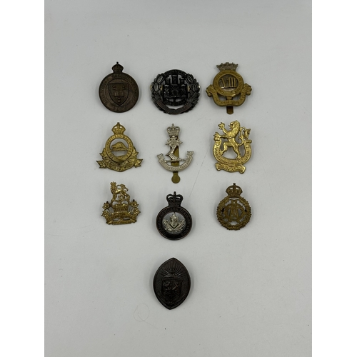 2179 - A collection of military cap badges