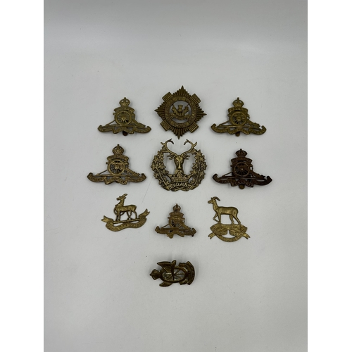 2182 - A collection of military cap badges