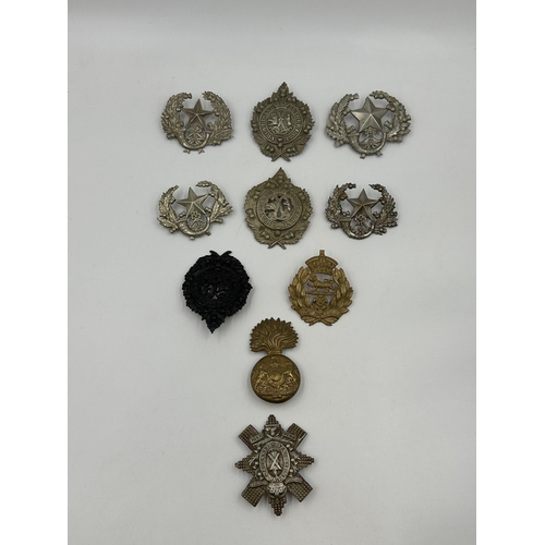 2183 - A collection of military cap badges