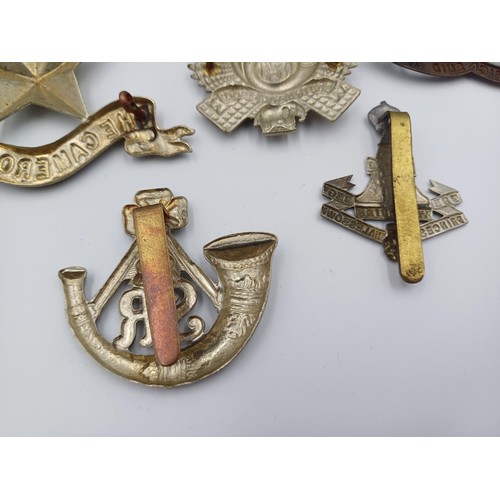 2114 - Ten military cap badges to include Argyll and Sutherland, The Robin Hoods, The Cameronians etc.