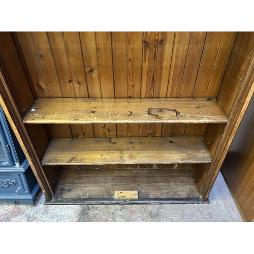 19 - A 19th century ecclesiastical pitch pine freestanding bookcase - approx. 208cm high x 137cm wide x 3... 