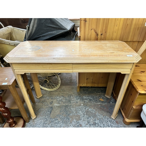 94 - A modern limed oak two drawer console table