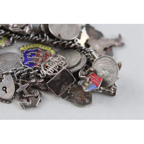 2039 - A silver charm bracelet with assorted charms - approx. gross weight 93g