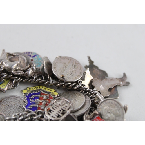 2039 - A silver charm bracelet with assorted charms - approx. gross weight 93g