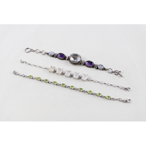 2055 - Three silver gemstone set bracelets to include moonstone, peridot etc. - approx. gross weight 40g