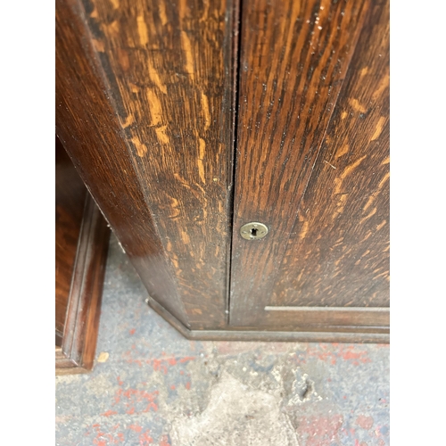 205 - A Georgian oak corner cabinet