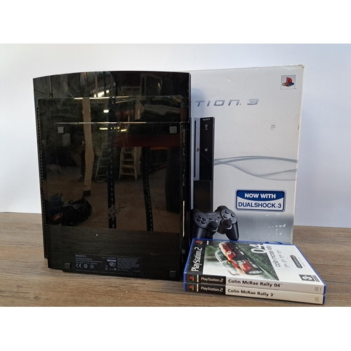 578 - A Sony PlayStation 3 console with box together with two PlayStation 2 games, Colin McRae Rally 3 and... 