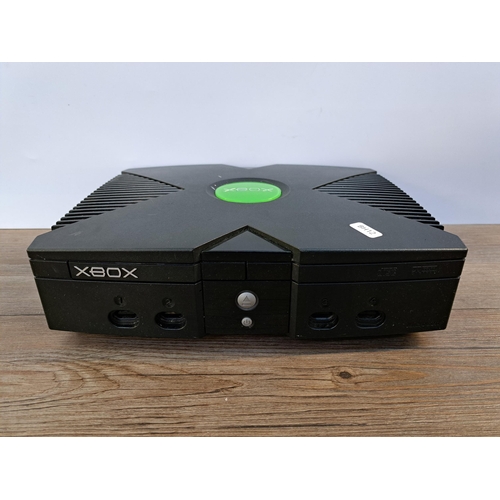 579 - A Microsoft Xbox console with controller, cables and games to include Call of Duty 2 Big Red One, St... 