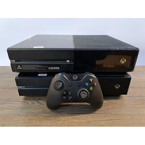 582 - Two Microsoft Xbox One consoles with controller