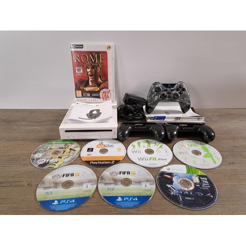 588 - A collection of video game related items to include Nintendo Wii console, Gioteck wireless third-par... 