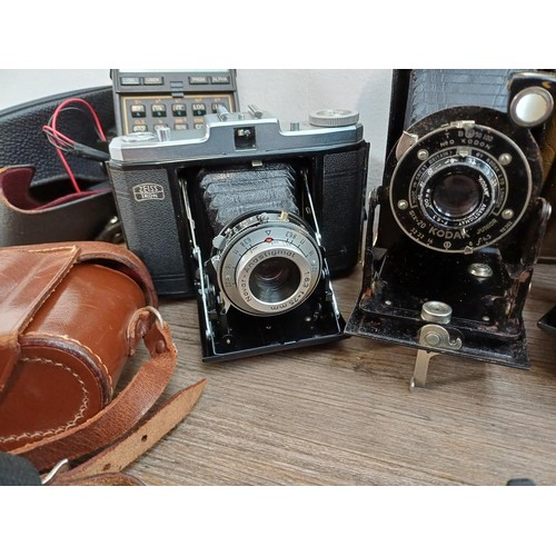 532 - A collection of items to include cased 1950s Zeiss Ikon Nettar II 517-16 horizontal folding camera f... 