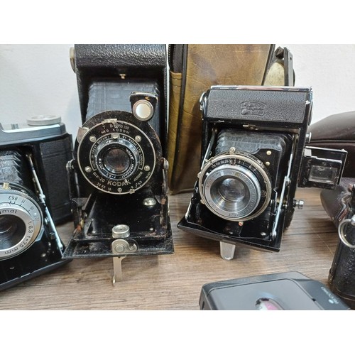 532 - A collection of items to include cased 1950s Zeiss Ikon Nettar II 517-16 horizontal folding camera f... 