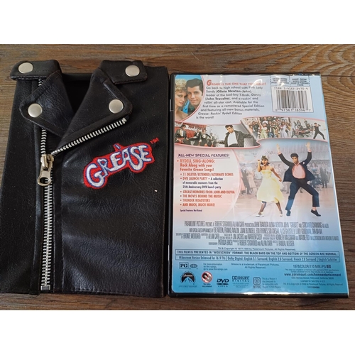 630 - A collection of DVDs to include Grease - Rockin' Rydell Edition with 'T' Birds jacket, 007 - The Jam... 