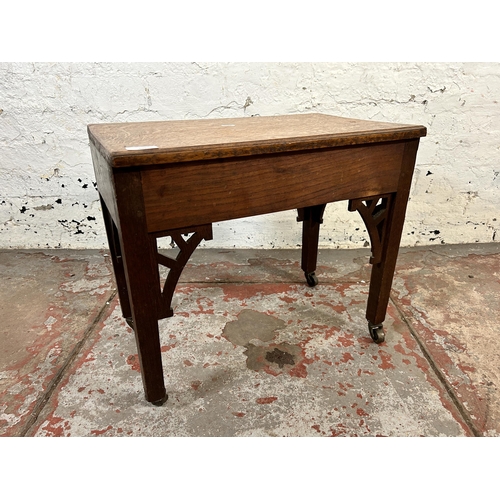 105 - A Georgian carved oak side table on later added castors - approx. 45cm high x 33cm wide x 52cm long