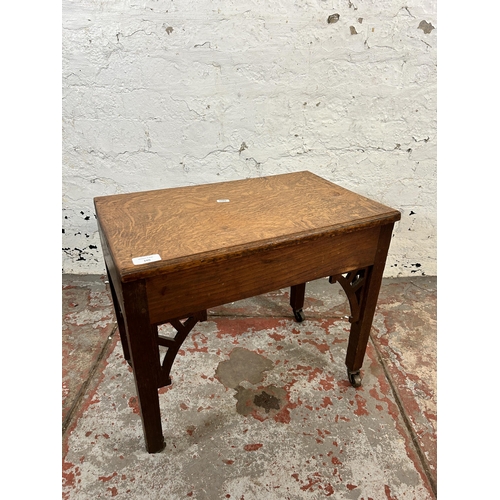 105 - A Georgian carved oak side table on later added castors - approx. 45cm high x 33cm wide x 52cm long