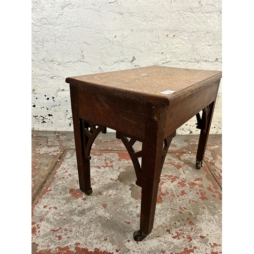 105 - A Georgian carved oak side table on later added castors - approx. 45cm high x 33cm wide x 52cm long