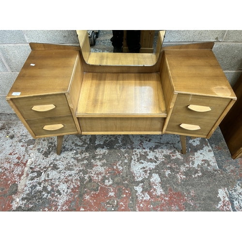 12 - A mid 20th century Avalon Yatton walnut dressing table - approx. 148cm high x 114cm wide x 45cm deep