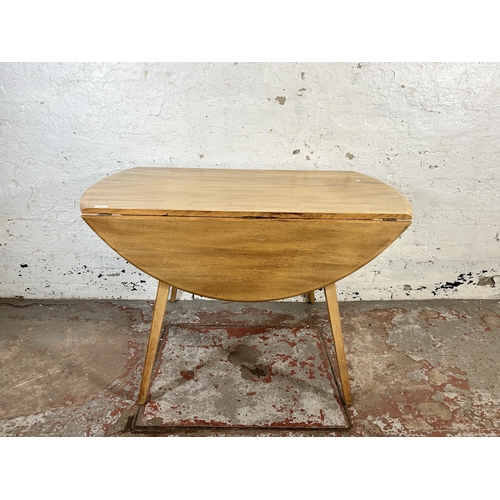 136 - A mid 20th century Ercol blonde elm and beech Windsor drop leaf oval dining table