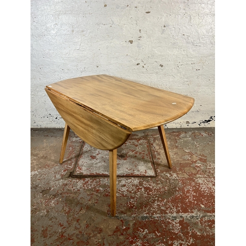 136 - A mid 20th century Ercol blonde elm and beech Windsor drop leaf oval dining table