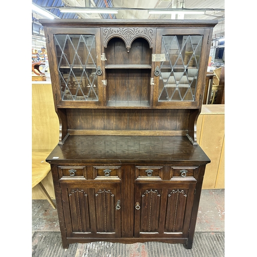 138 - A carved oak linenfold dresser - approx. 178cm high x 115cm wide x 45cm deep