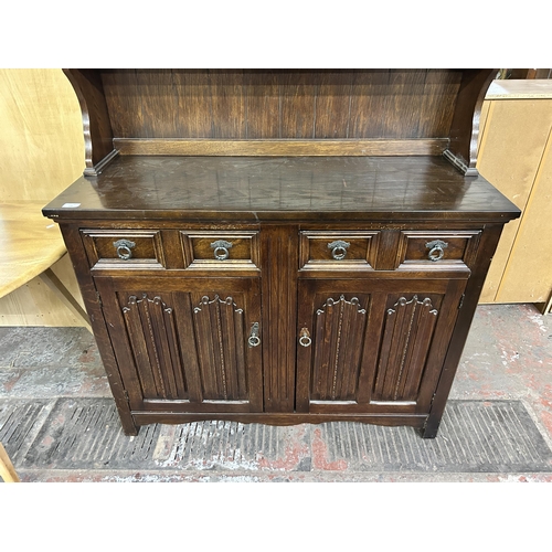 138 - A carved oak linenfold dresser - approx. 178cm high x 115cm wide x 45cm deep