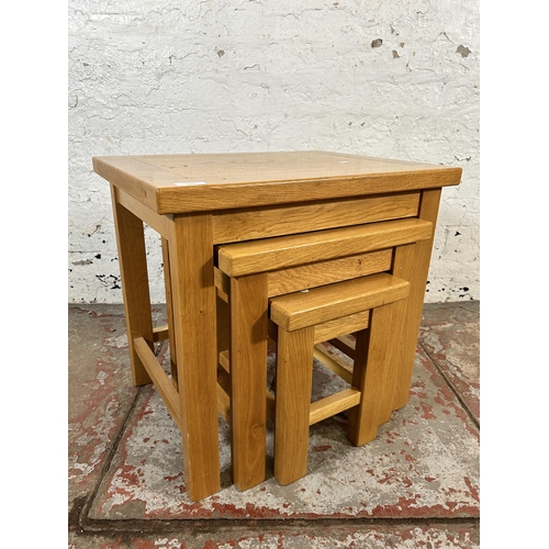 143 - A modern oak nest of tables - approx. 53cm high x 56cm wide x 43cm deep