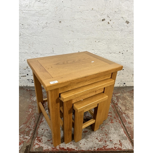 143 - A modern oak nest of tables - approx. 53cm high x 56cm wide x 43cm deep