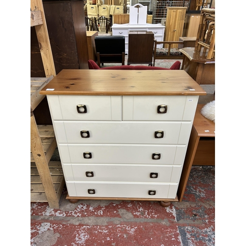 157 - A modern pine effect and white laminate chest of drawers - approx. 91cm high x 82cm wide x 40cm deep