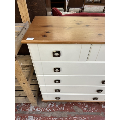 157 - A modern pine effect and white laminate chest of drawers - approx. 91cm high x 82cm wide x 40cm deep