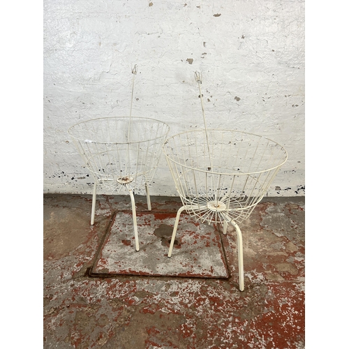 160 - A pair of wired metal shop display baskets on tripod stands - approx. 68cm high x 55cm diameter