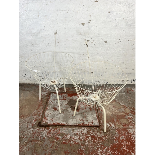 160 - A pair of wired metal shop display baskets on tripod stands - approx. 68cm high x 55cm diameter