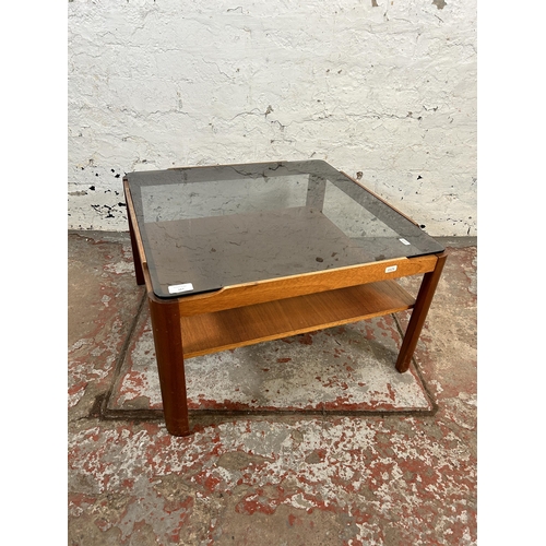 167 - A mid 20th century teak and smoked glass square two tier coffee table - approx. 35cm high x 61cm squ... 