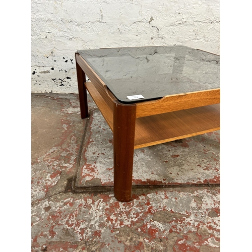 167 - A mid 20th century teak and smoked glass square two tier coffee table - approx. 35cm high x 61cm squ... 