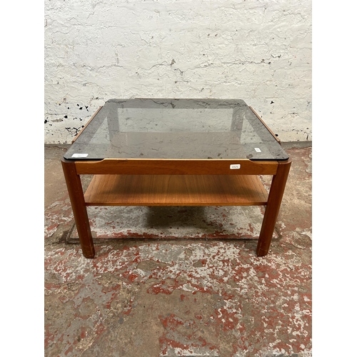 167 - A mid 20th century teak and smoked glass square two tier coffee table - approx. 35cm high x 61cm squ... 