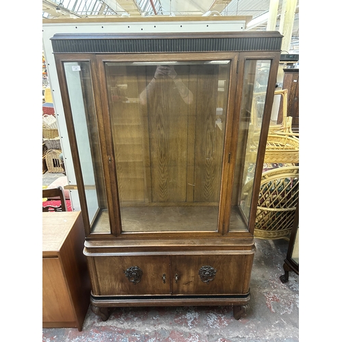 170 - An early 20th century carved oak display cabinet with bevelled glass door - approx. 185cm high x 109... 