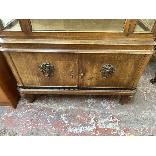 170 - An early 20th century carved oak display cabinet with bevelled glass door - approx. 185cm high x 109... 