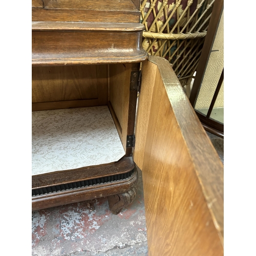 170 - An early 20th century carved oak display cabinet with bevelled glass door - approx. 185cm high x 109... 