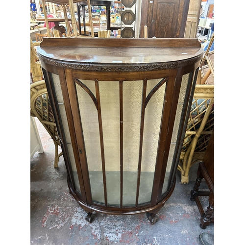 171 - An early/mid 20th century mahogany bow fronted display cabinet on ball and claw supports - approx. 1... 