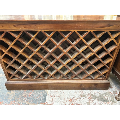 193 - An Indian hardwood bottle rack - approx. 84cm high x 129cm wide x 37cm deep