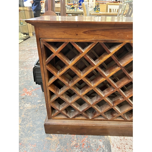 193 - An Indian hardwood bottle rack - approx. 84cm high x 129cm wide x 37cm deep