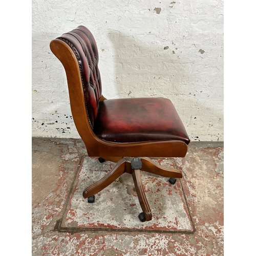 195 - A beech and oxblood leather Chesterfield swivel office desk chair