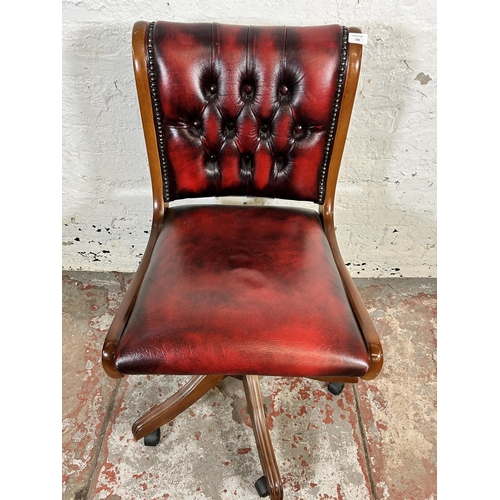 195 - A beech and oxblood leather Chesterfield swivel office desk chair