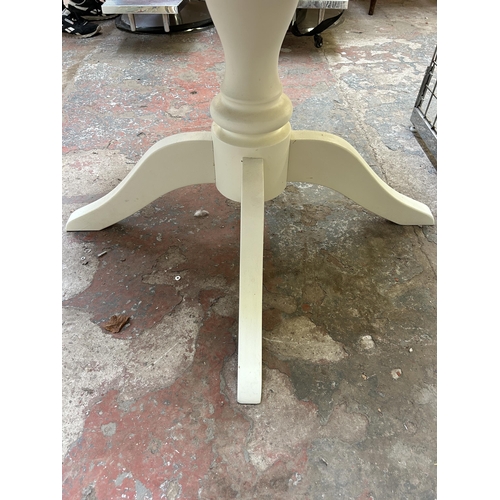 20 - A modern oak and white painted circular pedestal dining table - approx. 75cm high x 103cm diameter