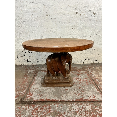 202 - A carved hardwood elephant design pedestal side table - approx. 48cm high x 60cm wide x 70cm deep