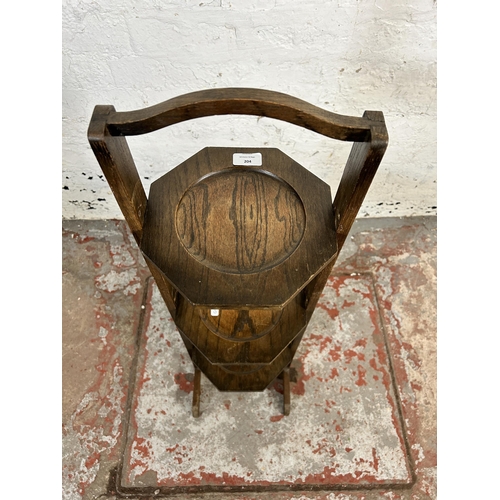 204 - An early 20th century oak three tier folding cake stand - approx. 91cm high