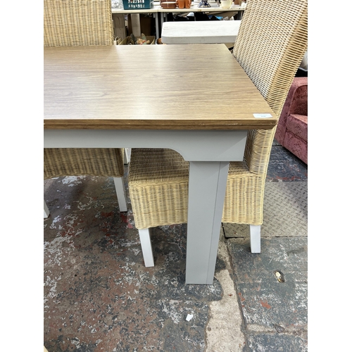 218 - A modern oak effect and grey painted dining table and four wicker chairs - approx. 75cm high x 90cm ... 