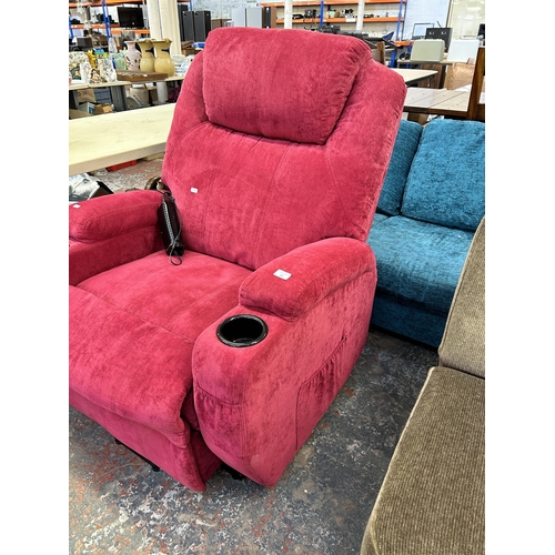 221 - A modern pink fabric upholstered electric reclining armchair with remote control and power supply