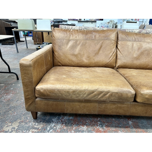 225 - A John Lewis tan leather three seater sofa - approx. 88cm high x 187cm wide x 97cm deep